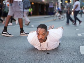 A man lays on the ground after yelling "Don't shoot me" at police during a rally in Dallas, Texas, on Thursday, July 7, 2016 to protest the deaths of Alton Sterling and Philando Castile. Black motorist Philando Castile, 32, a school cafeteria worker, was shot at close range by a Minnesota cop and seen bleeding to death in a graphic video shot by his girlfriend that went viral Thursday, the second fatal police shooting to rock America in as many days.