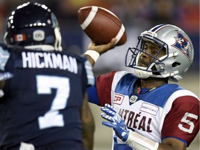 Toronto Argonauts' Justin Hickman, left, puts the pressure on Montreal Alouettes' Kevin Glenn during second half CFL action, in Toronto on Monday.