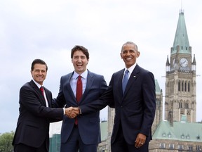 Prime Minister Justin Trudeau (centre), Mexican President Enrique Pena Nieto(left) and U.S. President Barack Obama(right) take part in a family photo at the North American Leaders' Summit in Ottawa, Wednesday June 29, 2016.
