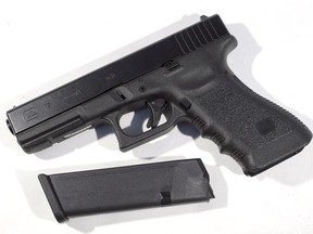 A Glock pistol with a 17 round magazine.