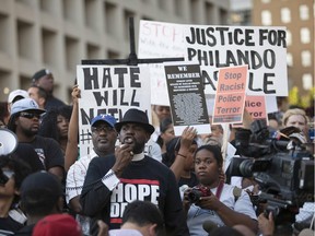 People rally in Dallas, Texas, on Thursday, July 7, 2016 to protest the deaths of Alton Sterling and Philando Castile. Black motorist Philando Castile, 32, a school cafeteria worker, was shot at close range by a Minnesota cop and seen bleeding to death in a graphic video shot by his girlfriend that went viral Thursday, the second fatal police shooting to rock America in as many days. /