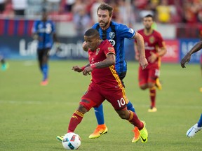 Real Salt Lake forward Joao Plata (10) dribbles the ball in front of Montreal Impact midfielder Eric Alexander (29) during the first half at Rio Tinto Stadium.