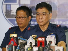 Philippine National Police Spokesman C/Supt. Wilben Mayor, right, and PNP Crime Laboratory Chief C/Supt. Emmanuel Aranas listen to questions from the media after reading the statement on the beheading of a Canadian hostage Tuesday, June 14, 2016, at Camp Crame in suburban Quezon city northeast of Manila, Philippines. Philippine officials have confirmed that Abu Sayyaf militants beheaded Canadian Robert Hall, the second Canadian hostage to be killed by Abu Sayyaf militants in two months after their demands for a large ransom were not met.