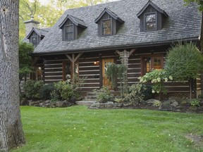 With its cedar shingled roof, dormers, stone chimneys and squared log walls, it looks just like a country cottage.