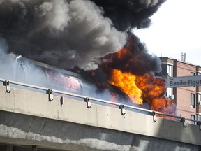 A tractor trailer carrying fuel burns on the elevated highway by Crémazie and Basile Routhier in Montreal Aug. 9, 2016.
