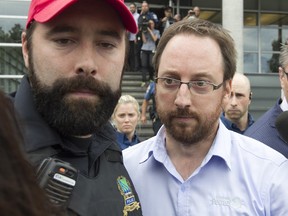 Jonathan Bettez is escorted out of the Palais de justice in Trois-Rivières on Tuesday, Aug, 30, 2016.