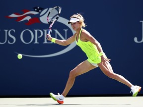 Eugenie Bouchard  returns a shot to Katerina Siniakova of the Czech Republic during her first round Women's Singles match on Day Two of the 2016 U.S. Open.