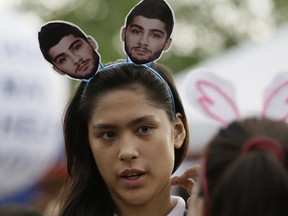 A Filipino fan lines up for a One Direction concert in 2015. Boy band member Zayn Malik is threatening a tell-all book that’ll knock Simon Cowell’s socks off.