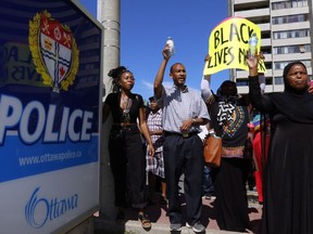 People assemble to honour Abdirahman Abdi in a protest at Ottawa's police headquarters on Saturday, July 30, 2016. Abdi, 37, died following a confrontation with police last Sunday in front of his home in downtown Ottawa.