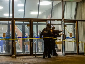 Campus security stand outside the scene at the Université de Montréal's Pavillon Roger-Gaudry where a work accident led to a man's death early in the afternoon on Friday, February 19, 2016.