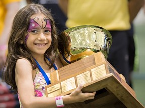 Alessandra Baltzis at the 14th Annual Games for Hope Corporate Sports Montreal fundraiser event held June 18, with the Top Team Fundraising Trophy: The trophy was won by WhiteHaven Securities, which raised $40,000. Alessandra's dad, Tommy Baltzis, is the company president. Photo by Cindy Morantz