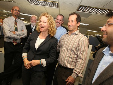 Los Angeles Times photographer Barbara Davidson (center), Jeff Gottlieb, second from right, and Ruben Vives, right, gather in 2011 after the announcement of Davidson's Pulitzer Prize for feature photography, for a series of photographs on victims of gang violence in Los Angeles.