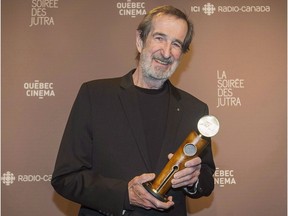 André Melançon holds up his honour award at the Jutra awards ceremony in Montreal, Sunday, March 15, 2015. Melançon has died at the age of 74.