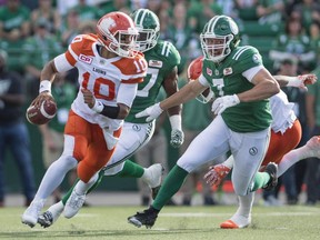 B.C. Lions quarterback Jonathon Jennings takes off with the ball under pressure from Saskatchewan Roughriders defensive-lineman Justin Capicciotti (#7) during first half CFL action in Regina on Saturday, July 16th, 2016.