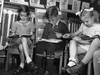 1946: Grade 1 pupils at Maisonneuve school, Joan Scarr, Rolf Wick and Gloria Jones, are learning all about Dick and Jane. Shoes were made of leather or suede, lace or buckle. Some boys wore pants just past the knees, with their thick socks meeting them halfway.