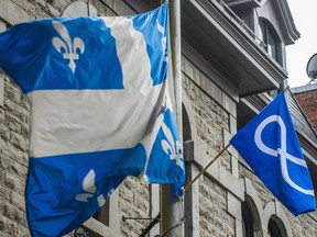 Montreal,  QC: July 20, 2013
Flags from Quebec and the Metis are waving outside the SociŽtŽ Saint Jean Baptiste , the SSJB is returning the historical Batoche Clock to Metis leaders on July 20 2013 in Montreal.