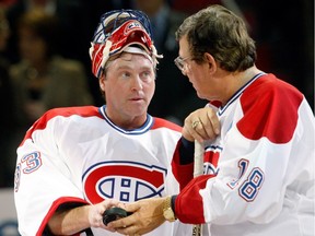 Former Montreal Canadien Serge Savard hands a puck to Patrick Roy during the centennial celebration ceremonies prior to the NHL game between the Montreal Canadiens and Boston Bruins on December 4, 2009 at the Bell Centre in Montreal, Quebec, Canada.  The Canadiens defeated the Bruins 5-1.