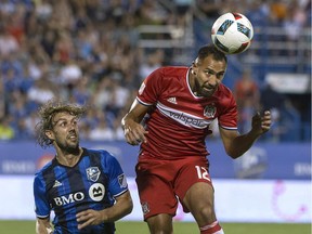 The Chicago Fire's Arturo Alvarez heads the ball as the Impact's Marco Donadel looks on during MLS game at Montreal's Saputo Stadium on Aug. 20, 2016