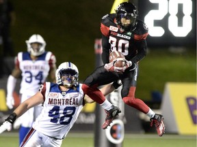 Alouettes' Bear Woods (48) defends against Redblacks' Chris Williams during second half of the game on August 19, 2016.
