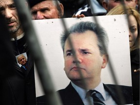 Supporters of the late Slobodan Milosevic hold his photo in front of the Museum of Revolution in Belgrade in 2006, where Milosevic's coffin was on display before he was buried. Milosevic, 64, was found dead in his prison cell while he was on trial at the UN war crimes tribunal in The Hague.