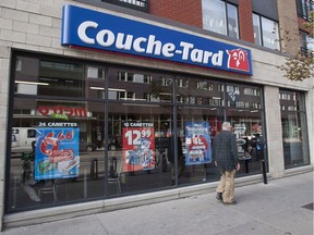 A man passes by a Couche Tard convenience store in Montreal.