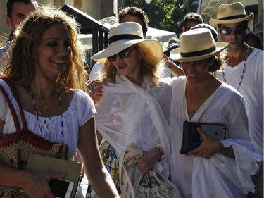 Singer Madonna walks along a street in Havana, where she was celebrating her 58th birthday, on Tuesday, Aug. 16, 2016.