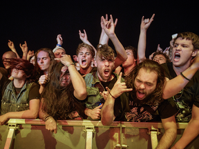 Music fans scream during the performance by the American metal band Disturbed on day two of the Heavy Montreal music festival at Jean-Drapeau Park in Montreal on Sunday, August 7, 2016.