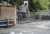 Residents look at the flooding on Brewster avenue near the corner of St-Antoine street caused by a water main break caused flooding in the borough of St-Henri in Montreal on Saturday, August 13, 2016.