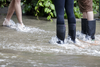 Residents wade through water on Brewster avenue near the corner of St-Antoine street at the scene where a water main break caused flooding in the borough of St-Henri in Montreal on Saturday, August 13, 2016.