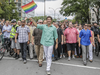 Canadian Prime Minister Justin Trudeau, centre, waves a pride flag as he takes part in the Montreal Pride Parade as it goes through Rene-Levesque boulevard in downtown Montreal on Sunday, August 14, 2016.