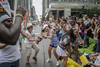 People dance as they watch the Montreal Pride Parade as it goes through Rene-Levesque boulevard in downtown Montreal on Sunday, August 14, 2016.
