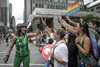 A roller derby player high-fives parade watchers during the Montreal Pride Parade as it goes through Rene-Levesque boulevard in downtown Montreal on Sunday, August 14, 2016.