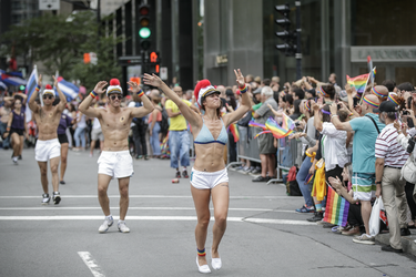 People take part in the Montreal Pride Parade as it goes through Rene-Levesque boulevard in downtown Montreal on Sunday, August 14, 2016.