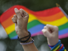 People raise their fists as they take part in a moment of silence during the Montreal Pride Parade on René-Lévesque Blvd. in downtown Montreal on Aug. 14, 2016.