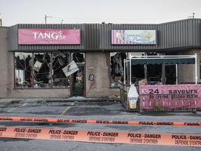 The damaged exterior of the ice cream shop Crèmerie St-Francois, right, which was firebombed with a molotov cocktail overnight, on Lévesque Blvd. East near the corner of Harmonie St. in Laval on Tuesday, August 23, 2016. The attack also damaged the restaurant Dynastie des Tang.