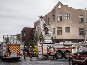 Firefighters at the scene of a residential fire at a building near the corner of de l'Eglise and Newmarch St. in Verdun Aug. 31, 2016.