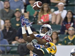 Alouettes receiver Duron Carter (89) and Eskimos defensive-back Patrick Watkins leap for ball during CFL game in Edmonton on Aug. 11, 2016.