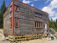 Eastern hemlock contributes to the rustic exterior of this mini house. The facade faces south for maximum sunlight and passive heat. (Photo by Perry Mastrovito)