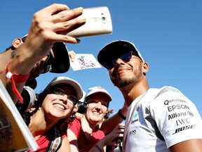 Mercedes driver Lewis Hamilton greets fans at the Spa-Francorchamps circuit on August 25, 2016, ahead of the Belgian Grand Prix.