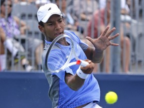 Montreal's Félix Auger-Aliassime hits forehand during a qualifying match against James Duckworth of Australia at the Rogers Cup in Toronto on July 23, 2016.