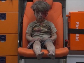 Five-year-old Omran Daqneesh sits in an ambulance after being pulled out of a destroyed building in Aleppo, Syria, on Wednesday.