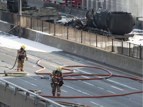 Firefighters wrap up following a fuel tanker fire on autoroute 40 during rush hour after colliding with at least two other vehicles Tuesday, August 9, 2016 in Montreal.