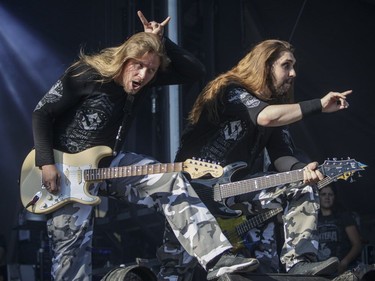 Guitarists Thorbjorn Englund, left, and Chris Rorland of the Swedish band Sabaton perform on Day One of the Heavy Montréal music festival at Jean-Drapeau Park in Montreal on Saturday, August 6, 2016.