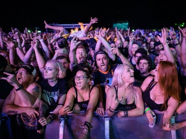 Fans cheer during the performance by American heavy metal band Five Finger Death Punch on Day One of the Heavy Montréal music festival at Jean-Drapeau Park in Montreal on Saturday, August 6, 2016.