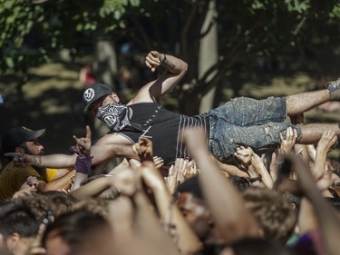 A fan crowd surfs during the performance by the American metalcore band Memphis May Fire on Day Two of the Heavy Montréal music festival at Jean-Drapeau Park in Montreal on Sunday, August 7, 2016.