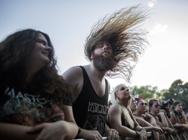 Music fans watch the performance by the American heavy metal band Mastodon on Day One of the Heavy Montréal music festival at Jean-Drapeau Park in Montreal on Saturday, August 6, 2016.