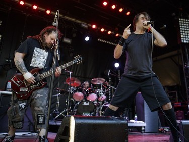 Barney Greenway, centre, of the British metal band Napalm Death performs on Day Two of the Heavy Montréal music festival at Jean-Drapeau Park in Montreal on Sunday, August 7, 2016.