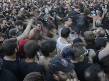 Music fans dance in the mosh pit during the performance by the American metalcore band Killswitch Engage on Day Two of the Heavy Montréal music festival at Jean-Drapeau Park in Montreal on Sunday, August 7, 2016.