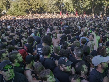 Music fans dance in the mosh pit during the performance by the American metalcore band Killswitch Engage on Day Two of the Heavy Montréal music festival at Jean-Drapeau Park in Montreal on Sunday, August 7, 2016.