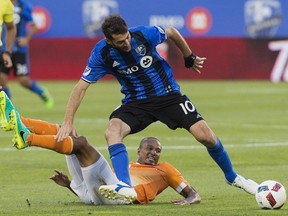 Montreal Impact's Ignacio Piatti (10) is challenged by Houston Dynamo's Ricardo Clark during first half MLS soccer action in Montreal, Saturday, August 6, 2016.